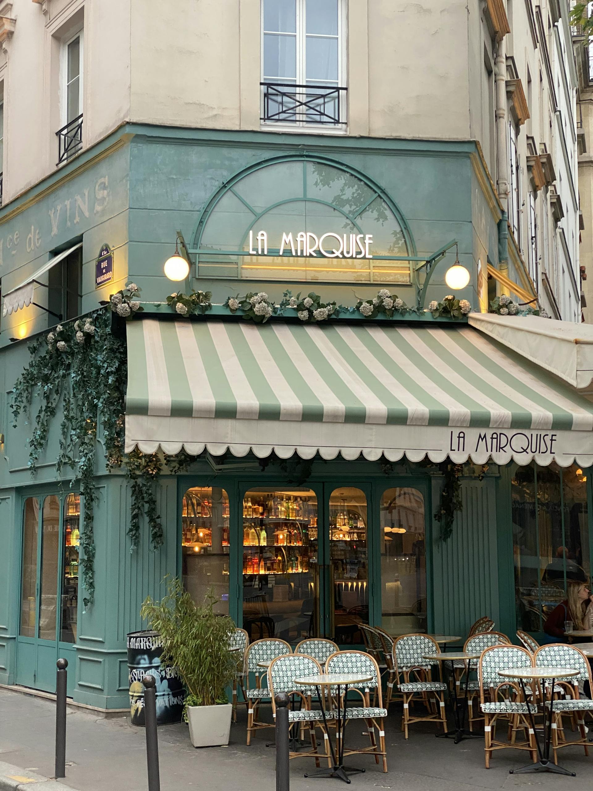 A picturesque outdoor view of La Marquise café in Paris with inviting seating and classic architecture.